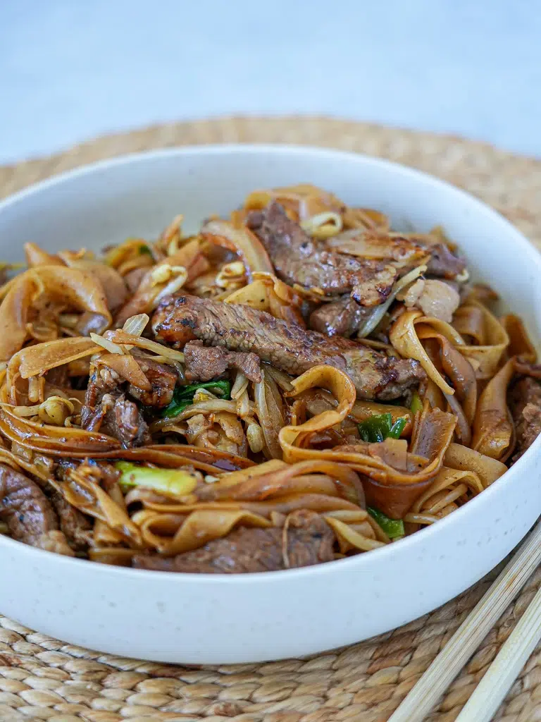 Delicious beef and rice noodles served in a bowl, topped with sliced beef