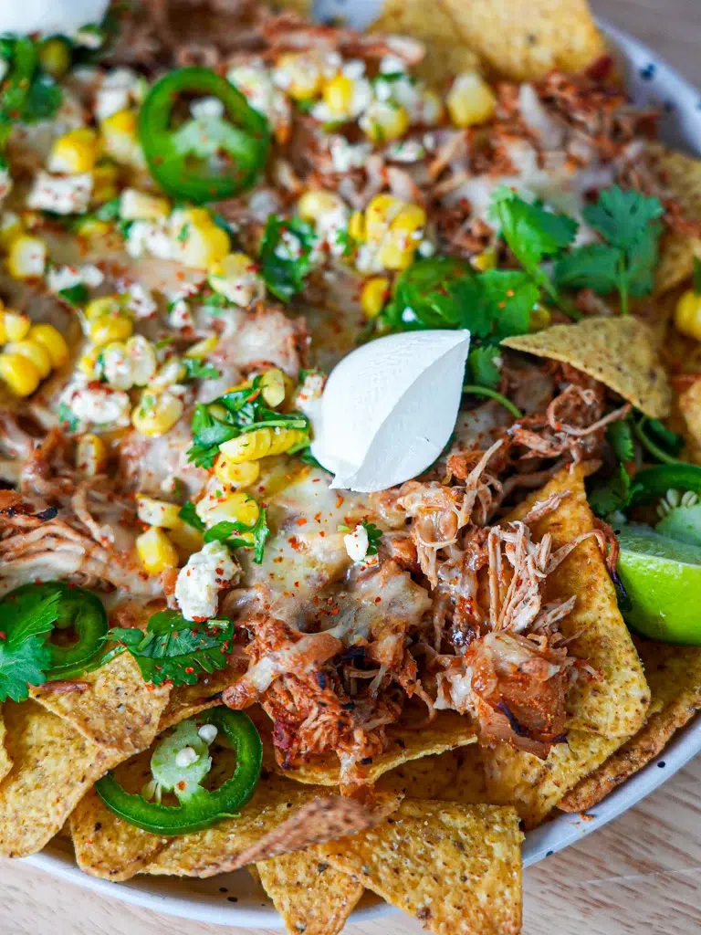 Golden, bubbling cheese melted over nachos, topped with a perfect corn mixture.